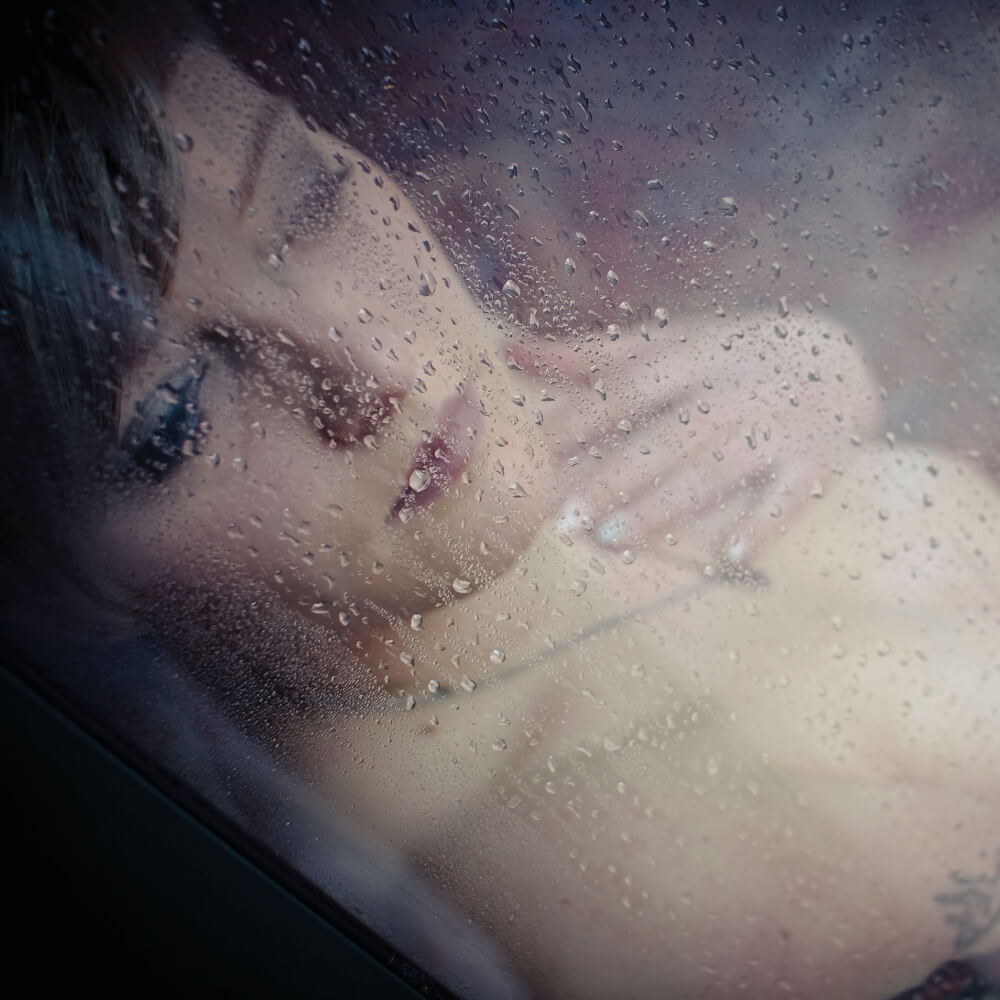 Sinnliches Shooting – Portraitaufnahme hinter einem Fenster bei Regen
